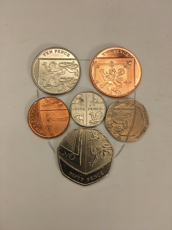 “When aligned in a specific way, the Pound Sterling coins make a coat of arms shield.”