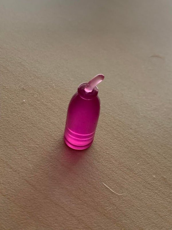 About 1 gram and 3 centimeters tall. Rigid, translucent plastic. Flat bottom. Found it on the bottom of a drawer. What’s this?

A: I think it’s a toy hamster water bottle. I remember having something like this when I was young with my Littlest Pet Shop set. The current orientation is upside down.