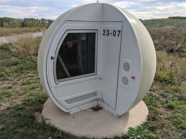 Spherical containers with valve and pipes inside. There must be at least 50 of these close to a stone-pit. What is it for ?

A: Biogas capture wells, on a former landfill.