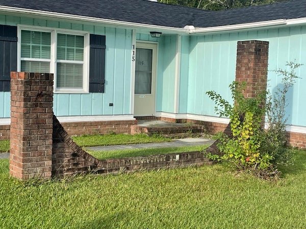 What is This Random Brick Structure?

A: I’m going to guess that this house was a model house for the subdivision, and the sign for the development was mounted between the pillars. I can’t find any mounting holes, but they might have been in the mortar before it was redone.