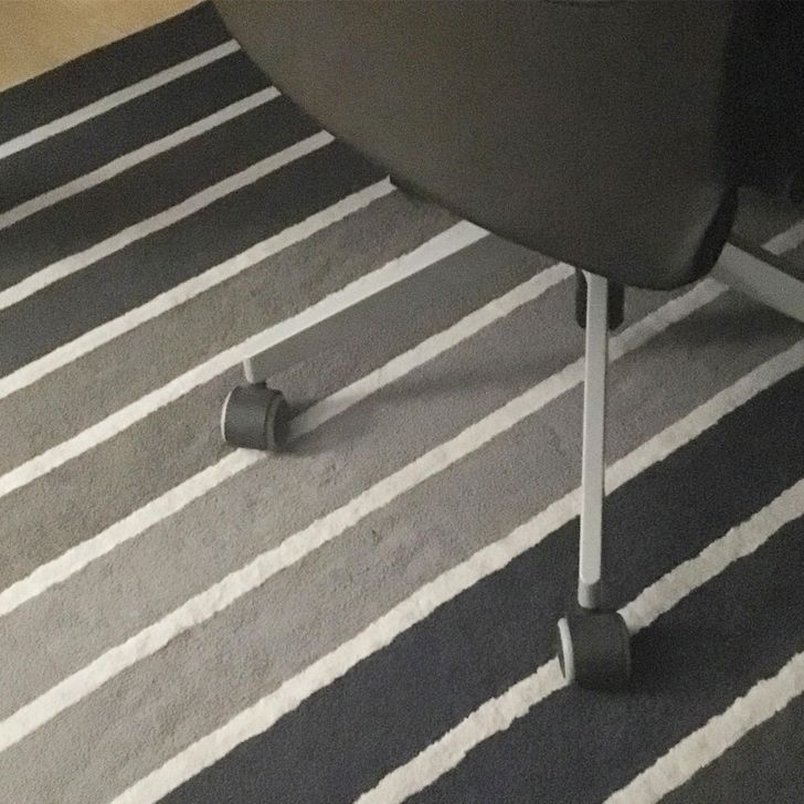 One of the chair’s legs blends in with the carpet.