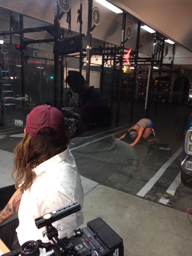 Making an exercise video; talent is so well lit in the gym that in the reflection behind us it looks like she’s stretching in the parking lot.