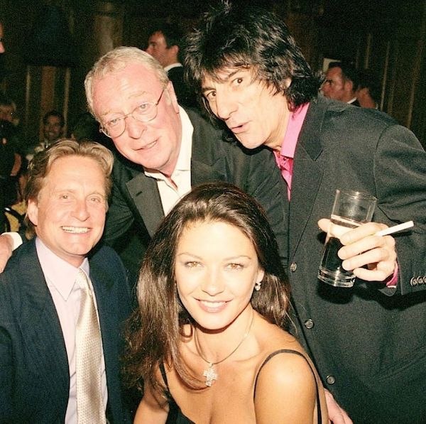 Michael Douglas, Michael Cain, Ronnie Wood, and Catherine Zeta-Jones back in the day.