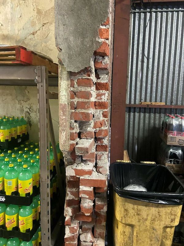 I guess they wanted an open floor plan? They took the brick wall separating the two rooms down. No permits, no contractor, just a man and his trusty hammer.