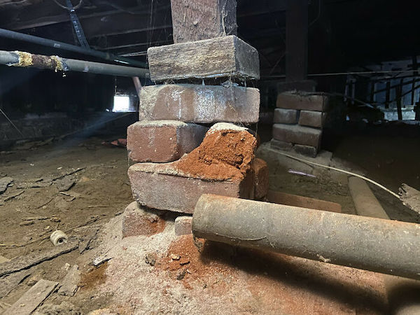 The brick and mortar piers are literally turning into dust. Not something you want holding up your entire house.