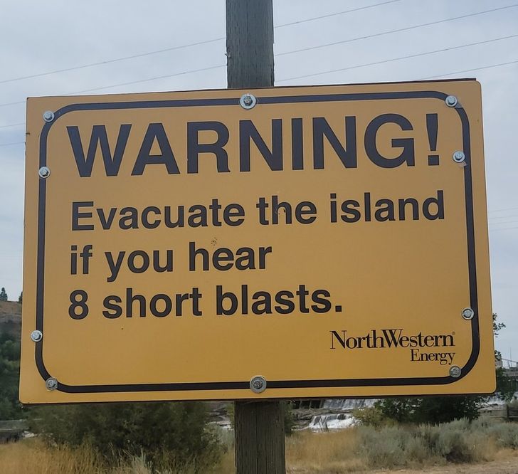 street sign - Warning! Evacuate the island if you hear 8 short blasts. NorthWestern Energy
