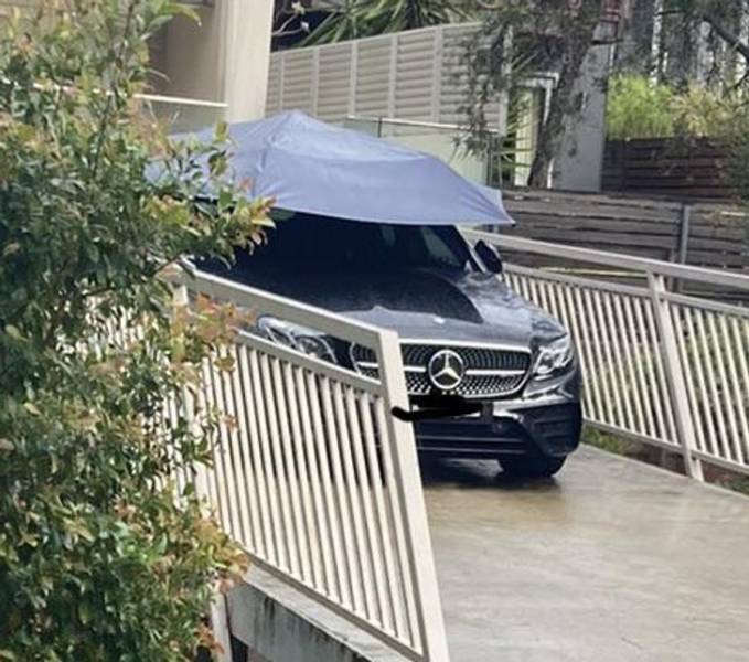 “This car in my neighborhood has an umbrella to keep it clean in the rain.”