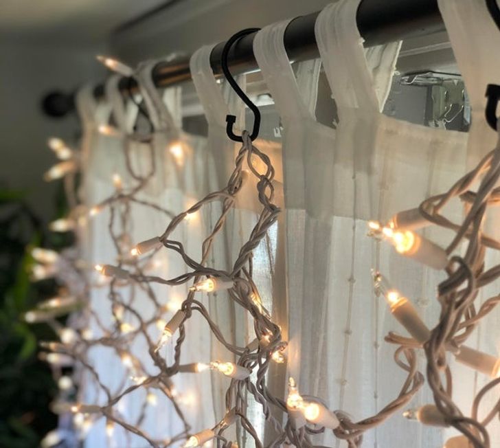“Shower curtain hooks work well for hanging holiday lights on curtain rods.”