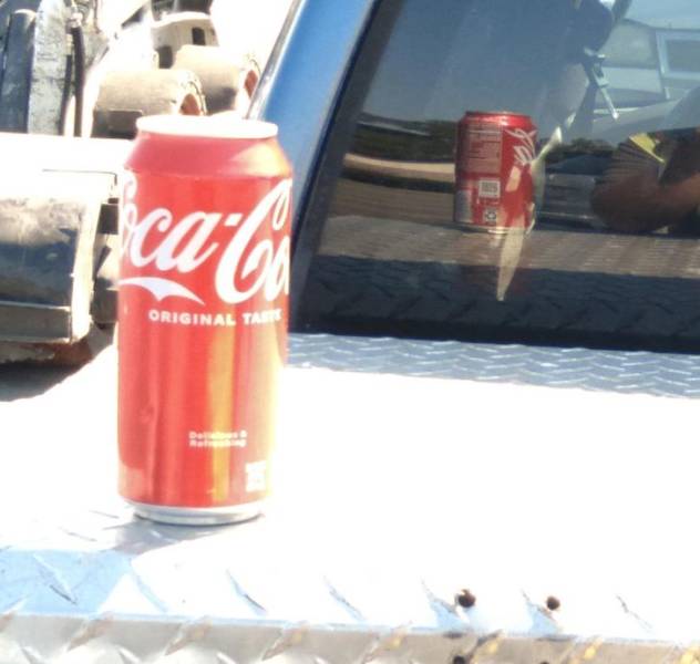 “The reflection of my truck window makes the tall soda can appear to be regular size.”