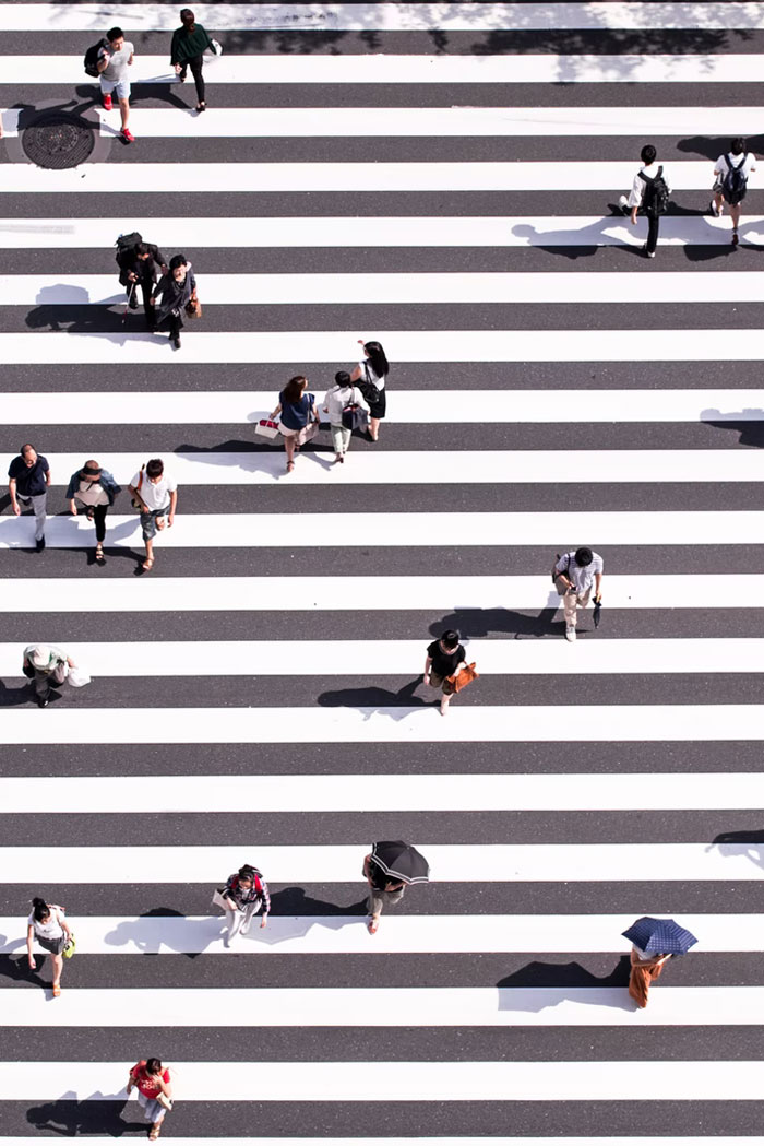 If someone walks in the opposite direction as you (walking towards you) you can start walking slower and they'll move out of your way. I don't know why but it works.