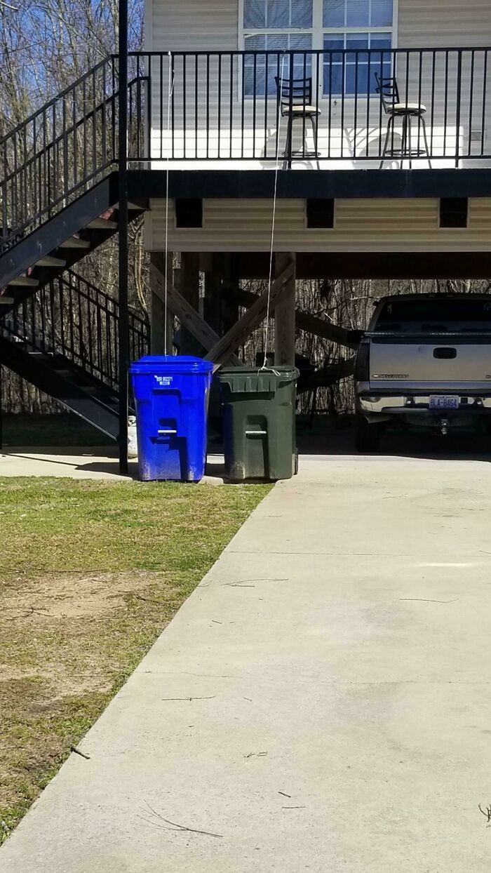 Tie A String To Your Garbage Cans So You Don't Have To Walk Downstairs