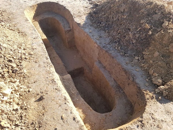 Weird excavations at the construction site of a highway. Symmetrical, look like sculpted out of the ground, 2-4 meters across, up to 1m deep. Only thing that comes to mind are archeological excavations? Or some kind of ground cross section analysis?

A: Most definitely archaeological excavations prior to the building of the highway. Most European countries have heritage laws that impose preventive archaeological surveys before major public projects. The shape of the “holes” is the result of a systematic search for archaeological artifacts at different stratigraphic levels.