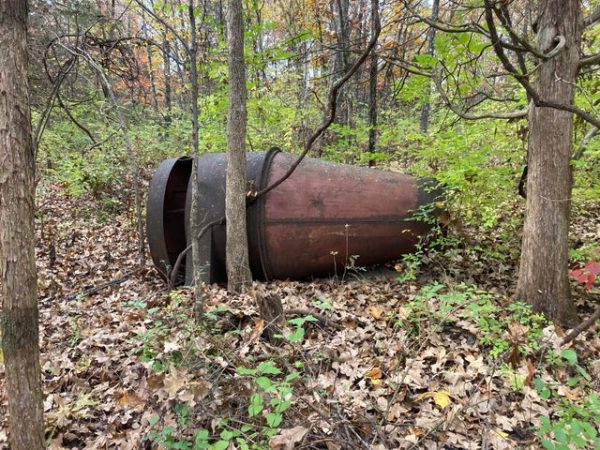 10 foot long metal thing. It is conical shaped, kinda of like a “spaceship”.

A: Grain hopper (feeding bin)