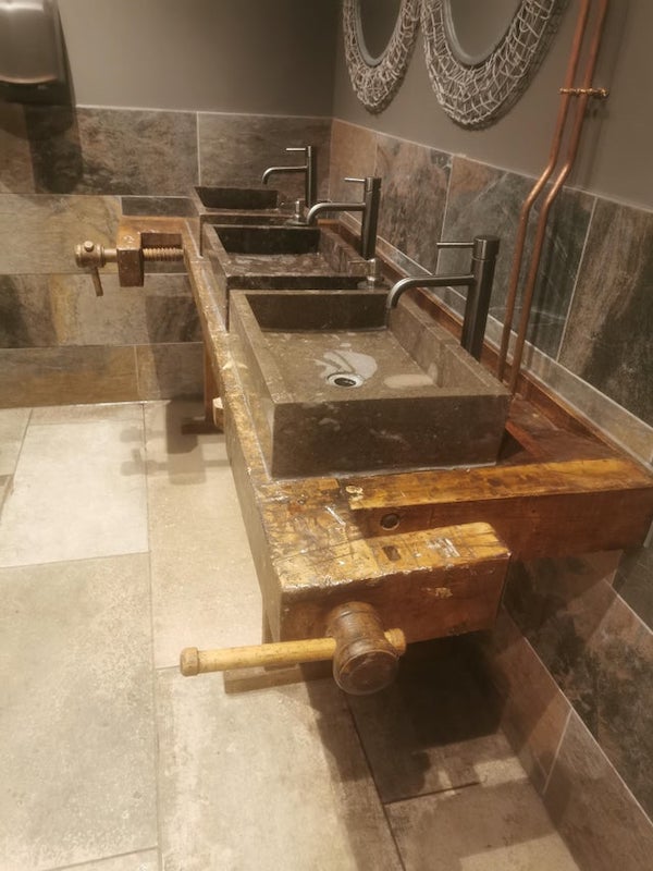 This wooden bench with big screws at either size repurposed into a basin desk in a toilet in a brewery in the UK

A: That is a tremendous WASTE of a really great old woodworkers workbench