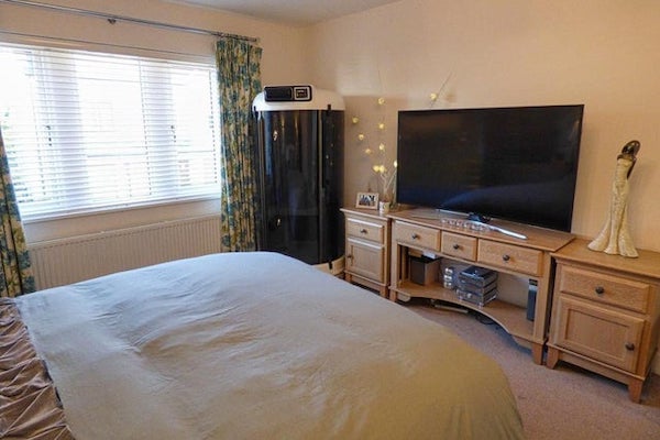 A white cubicle with a black glass screen and a control panel on top.

A: Portable steam room