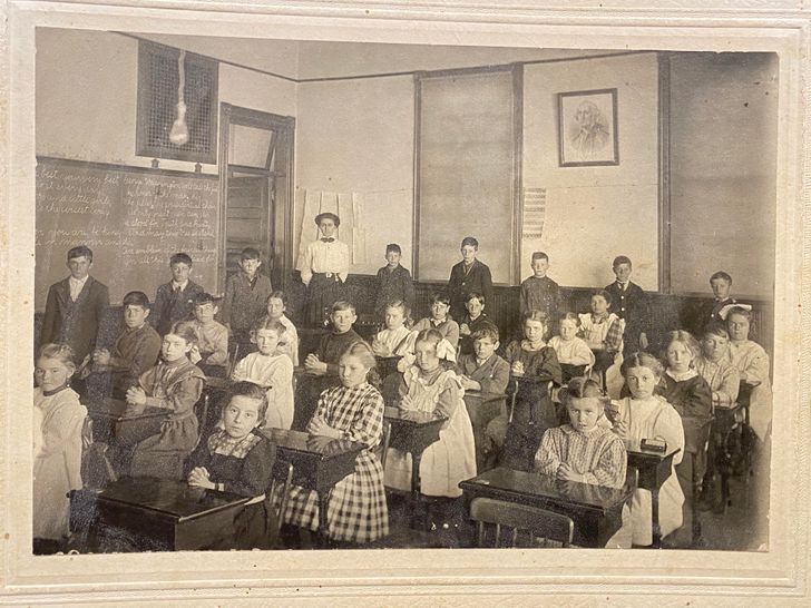 “Found this class picture from 1911 in the walls when redoing our kitchen. The back says, Vivien Gilbert June 1911.”
