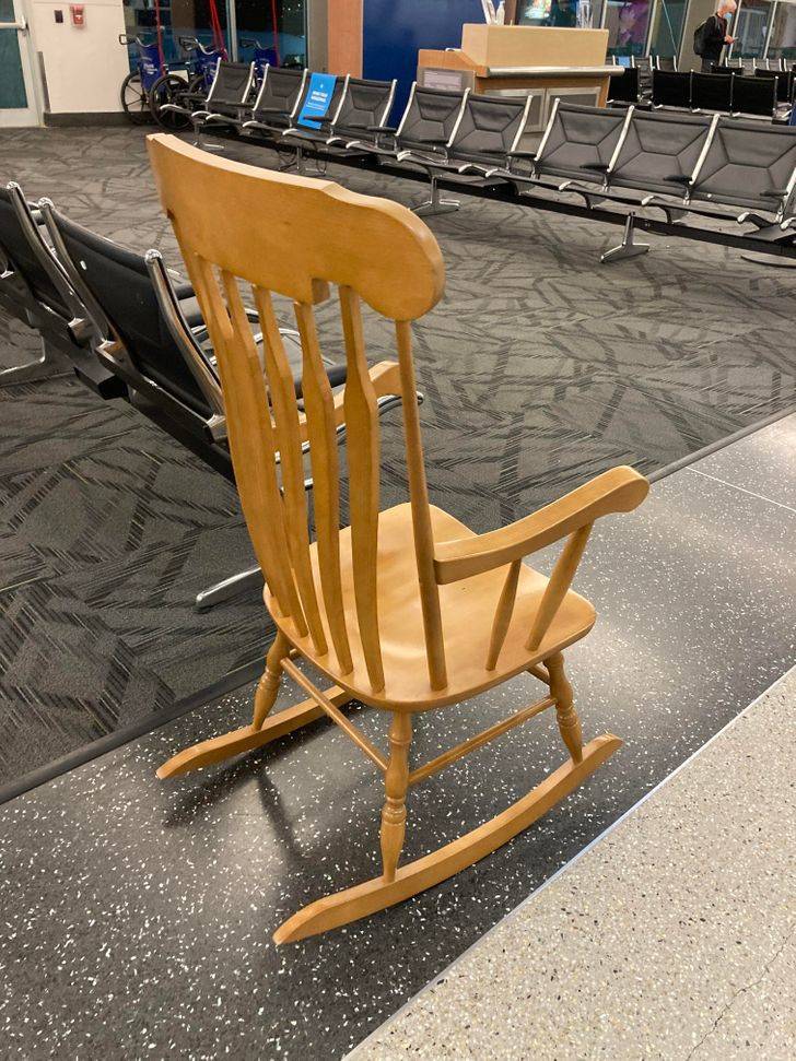 “A single rocking chair at a rural airport”