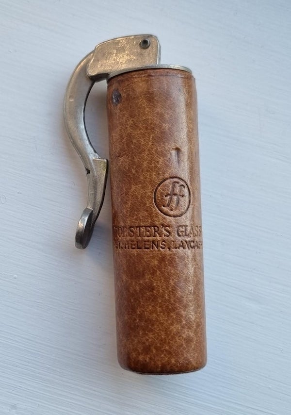 About 4″ high. Lever lifts up and can be unwound from cylinder which is leather covered and has a company name on it. Made in England.

Looks like a reusable Expanding cork for glassware/wine bottles.