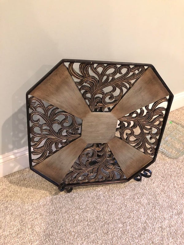 Octagonal and heavy. It came with a stand.

Looks like it could be a ornamental fireplace screen.