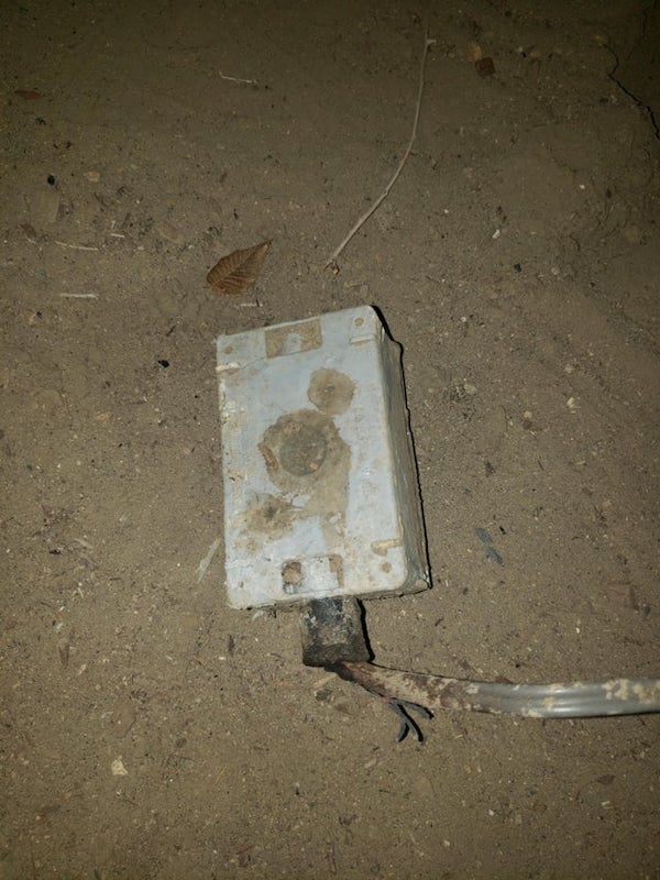 Found buried in the back yard, the cord runs underground, along the fence, and was plugged into the house. Seems hollow, something is loose inside when shake it.

It looks like a junction box that’s commonly used for local connection from buried cable to above ground fixture