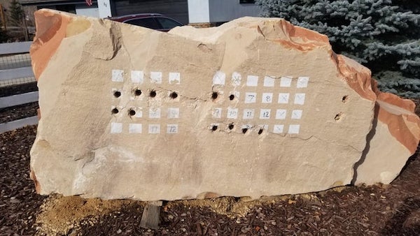 In someone’s front yard in Utah. A few neighbors had them. Holes were drilled into certain squares in the grid.

A: Drill holes to blast and remove ledge stone for the house.