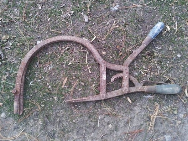 Shaped like a sickle, has two handles one with a ratchet like item on it. Friend found in her barn.

A: This is a valve spring compressor.. For a particular engine. Tractor most likely.