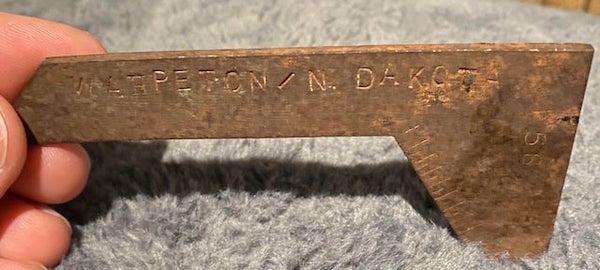 3.5” by 2” steel shaped L, possibly naval tool

A: It’s a drill sharpening gauge, the indications on the angled side is for checking lip length on the drill bit, and also verifys that drill bit has been ground concentrically and not eccentric.