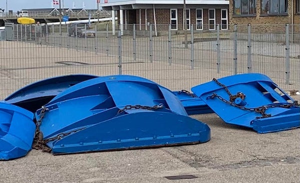 What are these blue, large (about 2m), heavy steel objects with chains and ropes attached that look as if they’re put under water (seen in a harbor)?

A: Those look like trawl doors aka otter boards. There’s 2 of them attached to the opening of a large fishing net to hold it open while it trawls.