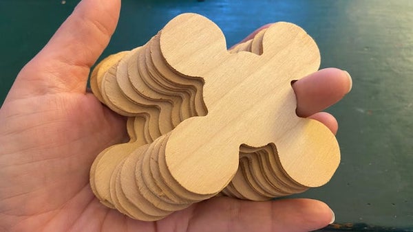 What is this set of identical flat wooden shapes found in an old box of Christmas decorations? I can sort of stack a few but they don’t really interlock. There are 10 of them.

A: We had these growing up. They are used to organize your ribbons, cords, strings etc for decorations or wrapping. You would start on one end and wrap your ribbon (etc) at a diagonal and then again to the other diagonal etc etc. it made sure none of your ribbons got tangled. We used these for ribbons, strings etc. you can also get them in plastic and larger sizes for a string of lights.