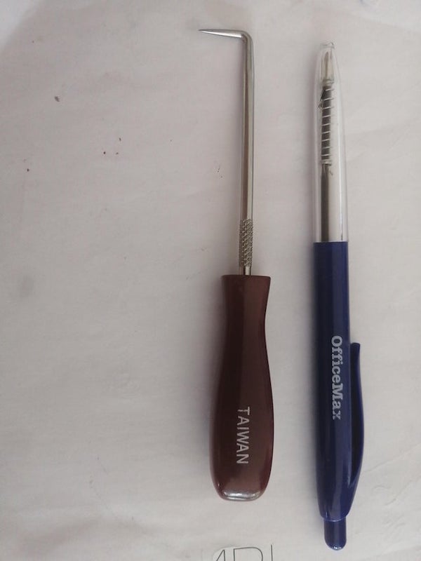 Does anyone have any idea what the tool on the left is? Used a pen for scale.

A: It’s just a pick (not a lock pick). Literally nothing specific, just for whatever you might find it handy for.