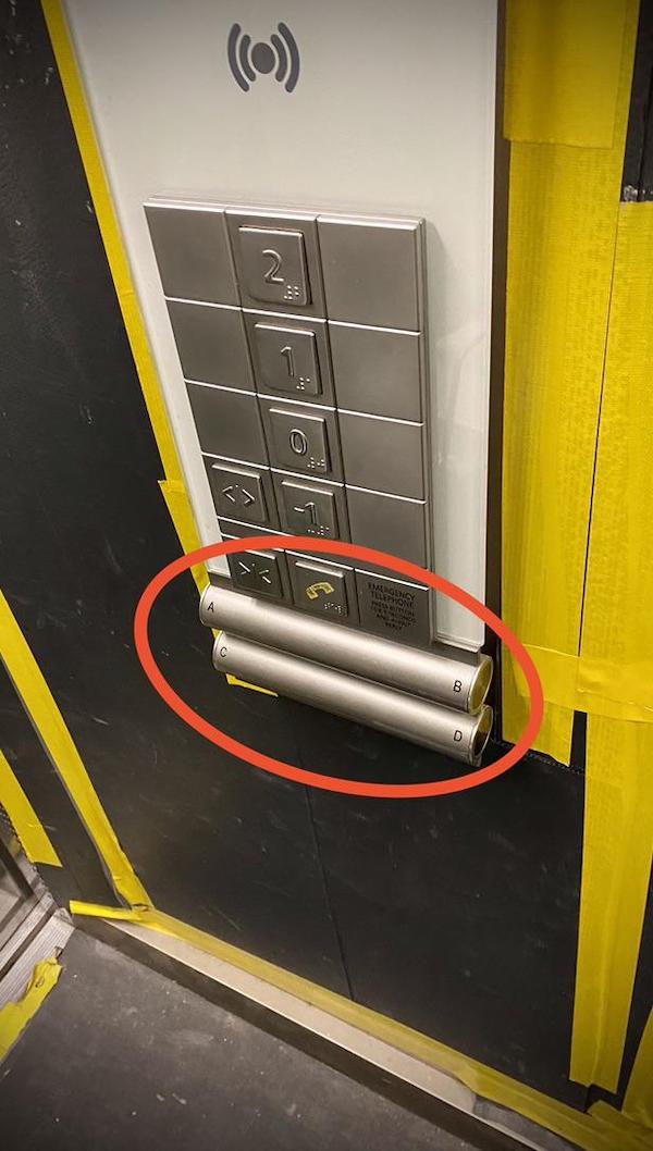 What are these two cylinders on an elevator/lift control panel labeled ABCD?

A: Those are for installing locks (normal keys with keyways) to enter areas e.g. floor 13. Keyways are at least 5cm (2″) deep so they needed a way to orient them sideways as the button assemblies are not deep enough. For smaller buildings where those are not needed those are just design elements.