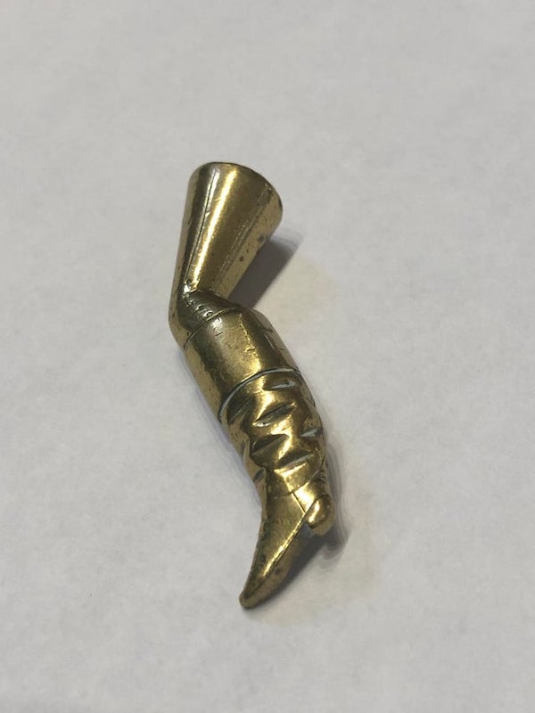 Tiny brass(?) leg found in antique shop.

A: It’s a tobacco pipe tamper