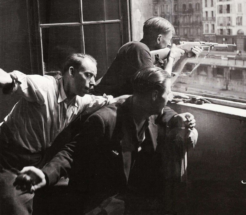 Parisian resistance fighters shooting at Nazi occupiers from a window, 1944