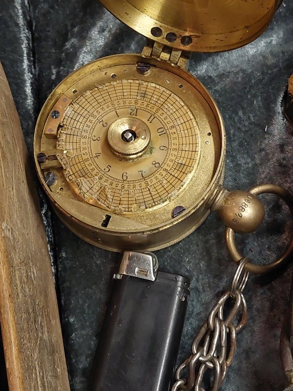 Disc shaped brass time keeping mechanism.

A: Night Watchman’s clock.