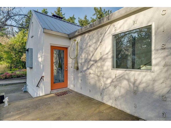 This yellowish rubbery tube-like thing hanging outside the front and back doors on a real estate listing for a house in Portland, OR.

A: It’s a light made by a designer.