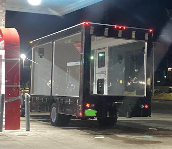 Clear back moving truck with door leading into the back

A: It’s advertising, when we did one they set up some sand inside and a little beach inside basically. Then just drive around and it definitely catches eyes. I don’t think they have real people riding in the back of it tho.