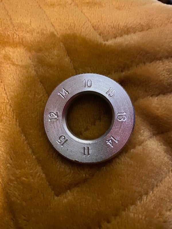 This came with a bike. It’s not on the instructions or parts list. I have absolutely no idea that this could possibly be. It has a diameter of about 2 inches

A: It’s a spoke wrench, for adjusting the tension of your wheel spokes. The numbers correspond to the spoke sizes.