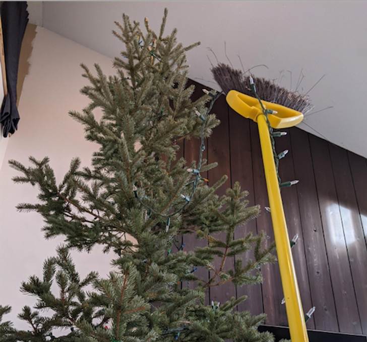 Brooms work quite well when putting lights up on tall trees.