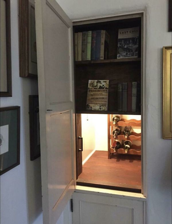 A secret prohibition-era liquor cabinet hidden behind a slide-up bookcase located in a neighbor’s house