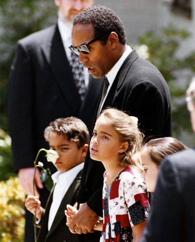 O.J. Simpson holding hands with his children Justin and Sydney at the funeral of their mother, and his ex-wife, Nicole Simpson Brown following her murder, Los Angeles, June 16, 1994