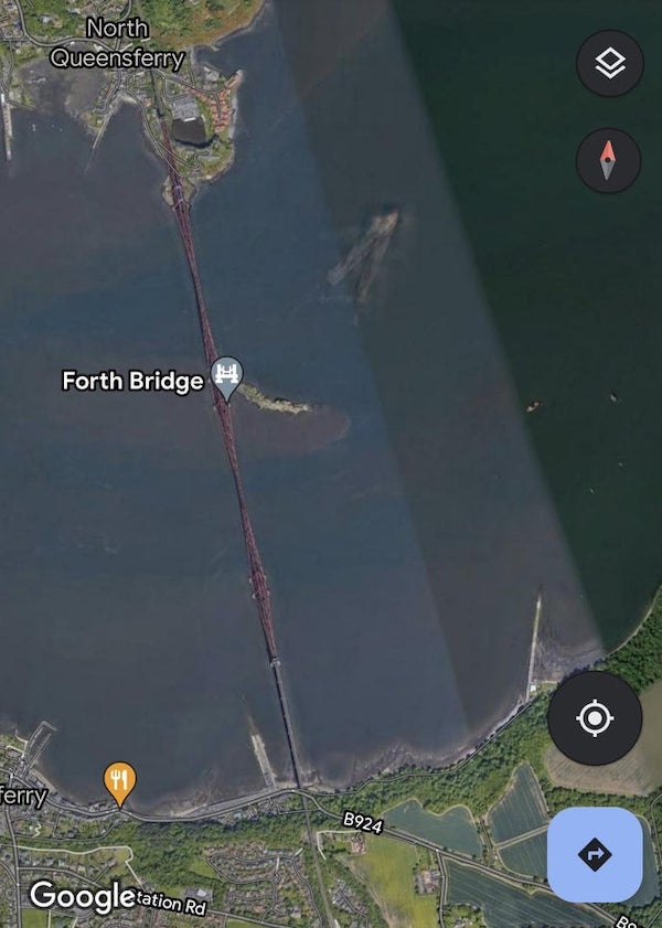 What are these large shapes in the Firth of Forth (Scotland) that look like sunken ships? Zoomed in photo and coordinates in second photo.

A: My guess is that since google earth is a combination of lots of photo, it’s multiple photos of the same ship and open sea all layered on top of each other.