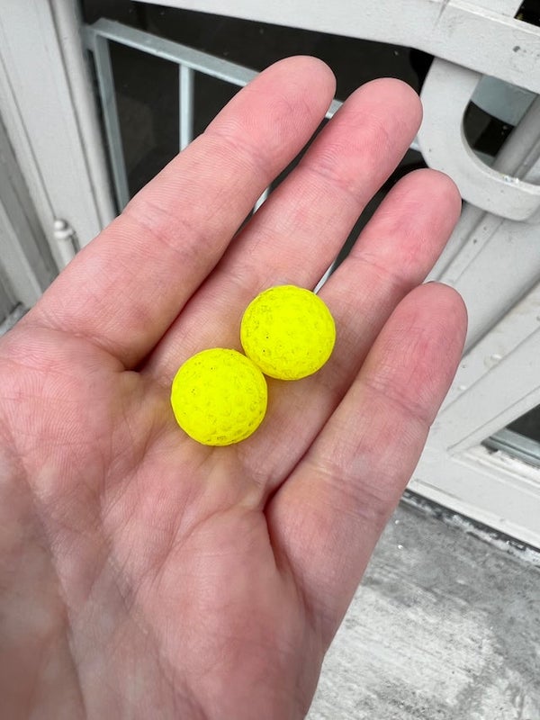 Squishy rubber balls a little less than 1/2 inch in diameter with divots. Found about a dozen in the street outside my house.

A: It’s Nerf ammo
