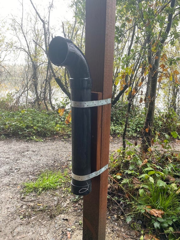 Black plastic pipe near entrance to a park. Has a wire coming out near the capped bottom.

A: It is for discarding / recycling used fishing line.