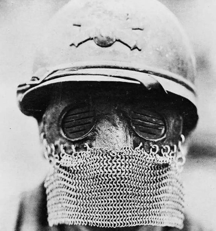 French tank gunner wearing a British Splatter Mask, October 12, 1918. The splatter mask was designed to help protect a tank crew member’s face from shrapnel when looking through the view ports. The mask was leather and had metal eye covers and a chainmail skirt to cover the mouth and chin.