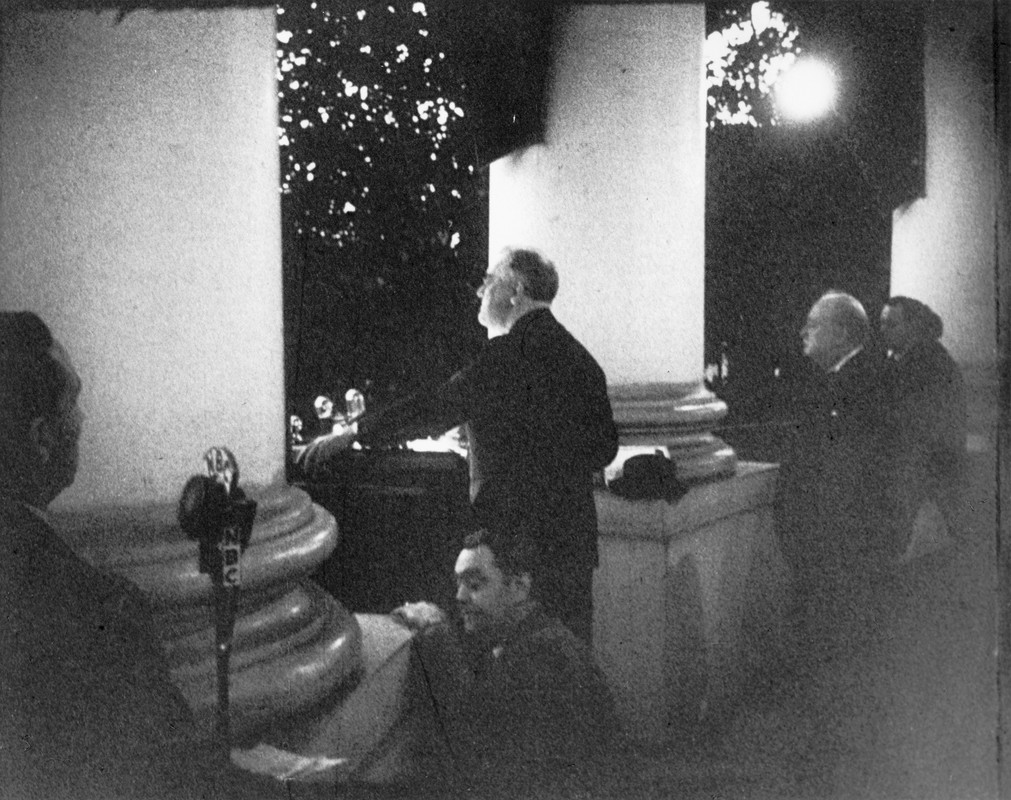 FDR addresses the anxious crowd regarding WWII at the Christmas tree lighting ceremony from the White House South Portico on Christmas Eve 1941. Winston Churchill can be seen on the right.