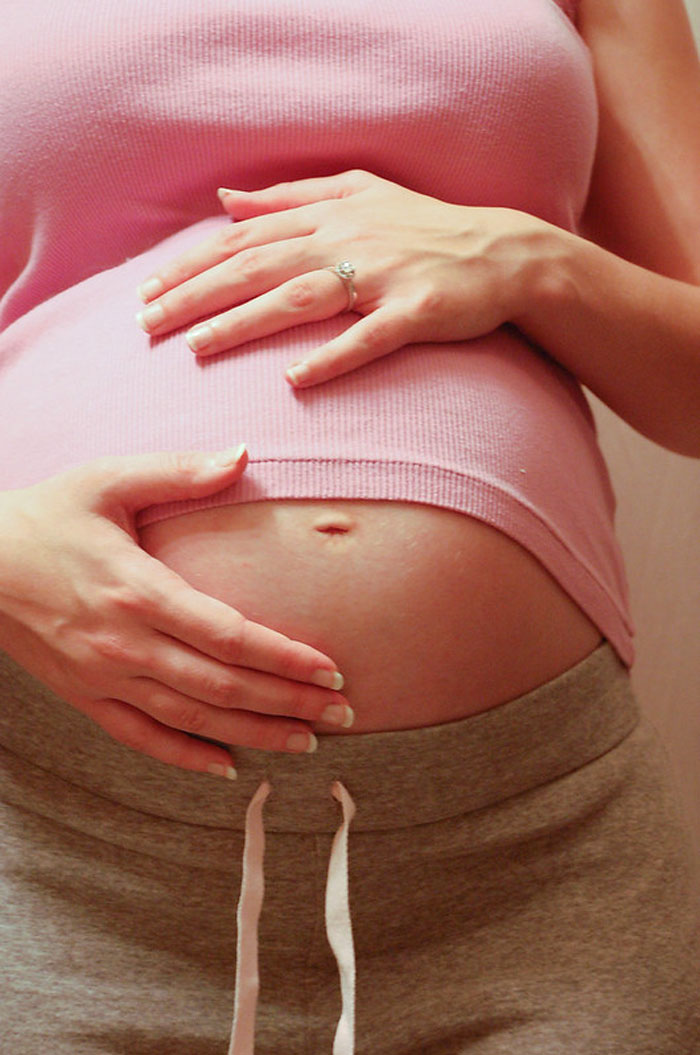 gut instincts - survivor stories - pregnant women holding belly