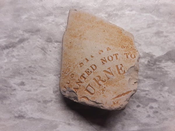 Pottery shard unable to read all words other then “not to” seems very old. Found on Dominion Beach, Nova Scotia, Canada.

A: The text doesn’t quite line up in the same way, so it’s not identical, but it appears to be a “vitreous stone” ink bottle from J. Bourne, “warranted not to absorb”