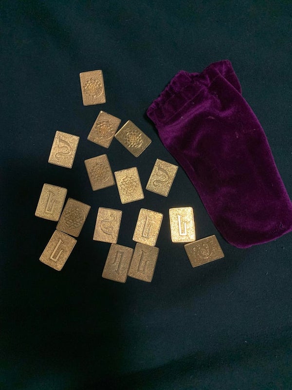 What is this velvet sack full of small, gold, metallic plates with an frost texture?

A: They are replica coins from the original (1970s) “Battlestar Galactica”. The characters wagered on space poker (“Pyramid”) with these coins (“cubits”) on the show.