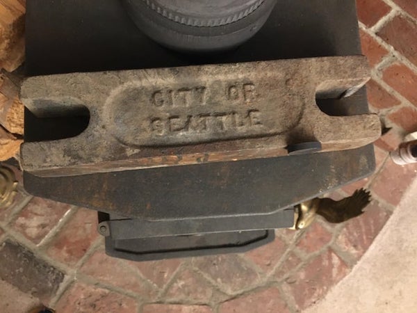 What is this 25 pound magnetic metal block stamped with “city of seattle” for?

A: It’s for weighted curtains in a theater.