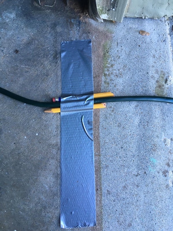Protect your extension cords against the garage door this Christmas. 1 pencil + duct tape.